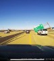 Strong Winds Blow Freeway Sign onto the Road