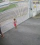 Girl Hangs on While Dad Opens Gate