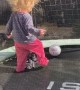 Little Girl with Wild Hair Plays on Trampoline