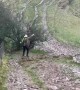 Hiker Manages Slippery Descent on Mud