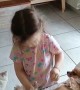 Little Girl Puts a Diaper on Her Dog
