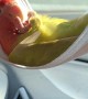 Parrot Chills Out in Face Mask Hammock