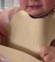 Baby Tries to Take Her Bib Off