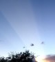Light Beam From Setting Sun Shoots Across Sky
