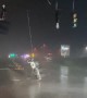 Stop lights dangle from extreme Hurricane Nicole damage