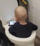 Kid Sits in Toilet While Watching Cartoons