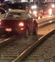Car Drives Down Train Tracks