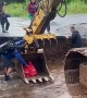 Man Uses Backhoe To Cross Washed Out Road and Bring Home Groceries