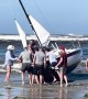 Beachgoers Work to Rescue Boat