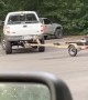 Oblivious Driver Turns Over Trailer