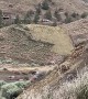 Construction Workers Demolish A Hilltop