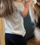 Girl Sweetly Serenades Dog