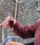 Skier Enjoys a Meal on Chairlift