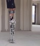 Worker on Stilts Shows How to Pick up Dropped Tool