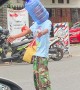 Man Directing Traffic Wears Water Jug in Indonesia