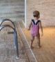 Little girl fearlessly jumps into the pool