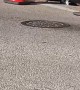 Worker Chucks a Brick From Manhole