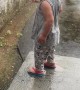Boy Splashes In Rain Gutter Runoff