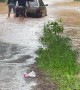 Men Push Car Through Flooded Street