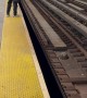 Man Walking Down Train Tracks