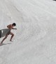 Gliding Down Snowy Slope Into Mountain Water