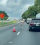Driver Weaves in and Out of Cones in Traffic
