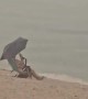 Man Doesn't Let Rain Ruin His Beach Day
