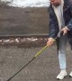 Canadian Helps Guide a Raccoon Using a Hockey Stick