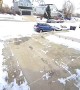 Kid slips on ice while carrying a shovel