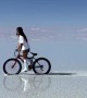 Woman Rides Bike At Bolivia's Salar de Uyuni