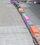 Little Boy Walks Giant Train Down Sidewalk
