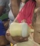 Sports Game Distracts From Bottle Feeding Baby