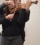 Two Musicians Perform on Single Violin