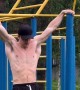 Man Does Pull Up Stunt on Playground Equipment