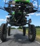Driving a Motorcycle Under a Field Sprayer