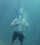 Freediver Blows Bubble Ring From Sea Bottom