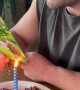 Guy Reading a Birthday Card as the Candle Lights It on Fire
