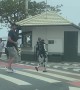 Man Pilots Walking Robot Across Pedestrian Crossing