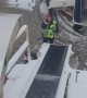 Airplane Luggage Keeps Sliding Down Icy Conveyor Belt