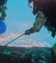 Divers Clean Boat Upside-Down