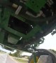 Biker Rides Underneath Sprayer Tractor
