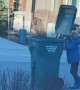 Boy Struggles With Trash Can in High Winds
