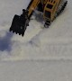 Miniature Excavator Works To Clear Snowfall