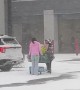 Kind Girl Helps Stranger Push Shopping Cart Through Snowstorm