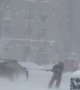 Lamborghini Huracan Pulling a Skier Down Snow-Covered Street