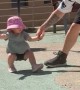 Dad Keeping His Little Girl Steady After a Dizzying Spin at the Park