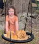 Little Girl Pushes Chickens on a Swing
