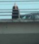 Bridge Monk Stands Ominously Over Oncoming Traffick in Portland