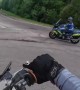 Motorcycle Driver Cuts Across Roundabout Just as Police Pull Up