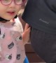 Girl on Bike Biting Dad
